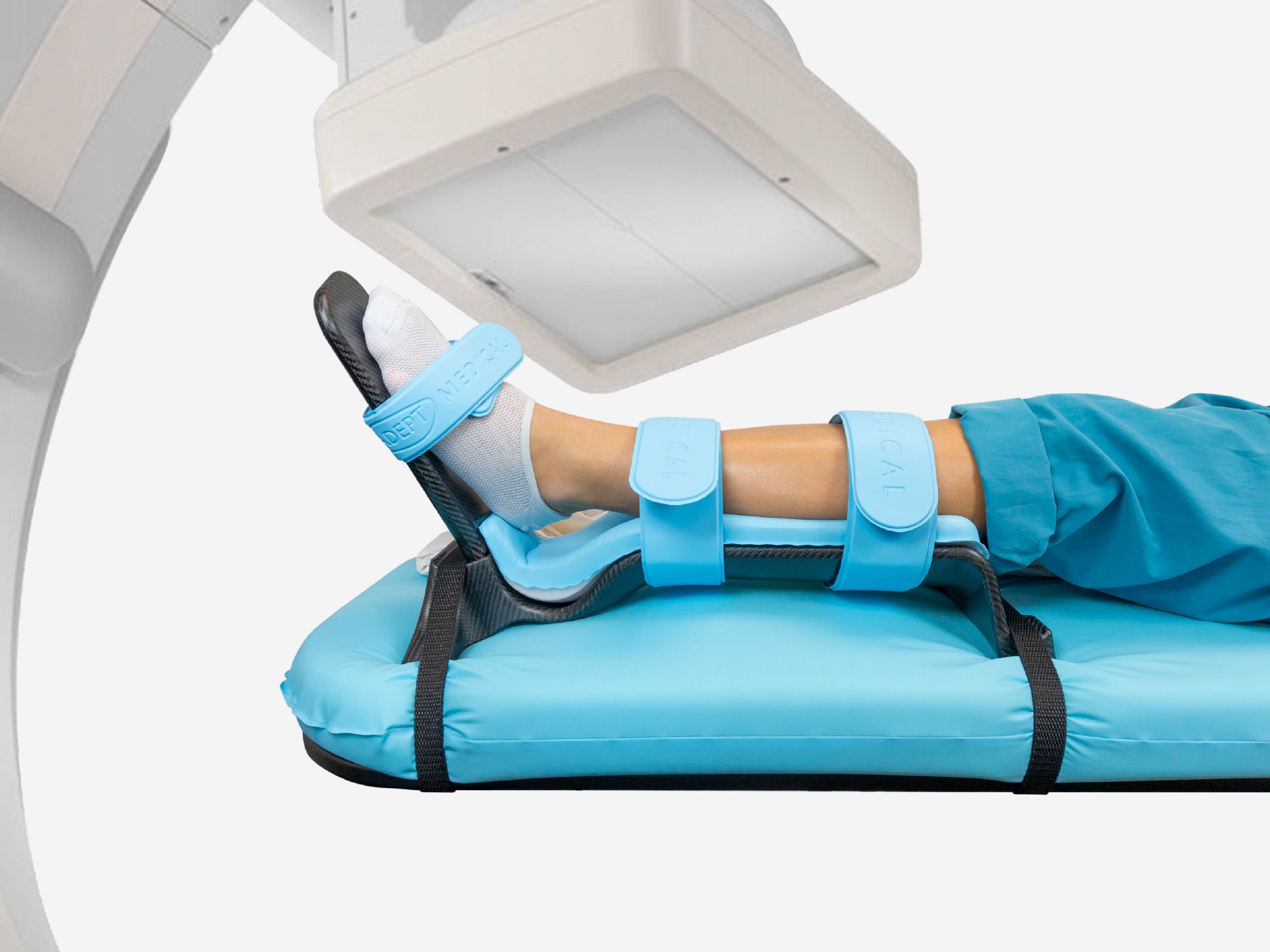 A patient's head visible under a blue surgical drape that forms a tent, with medical tools on it.