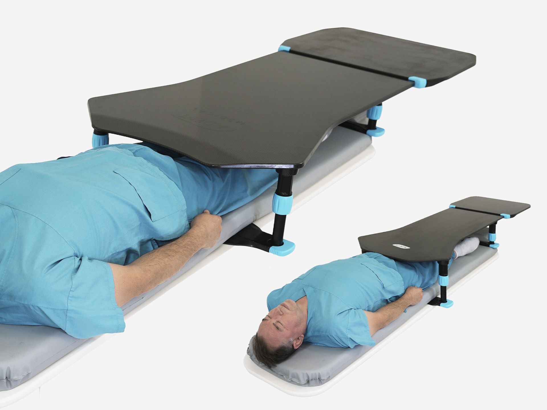A person lies on a medical bed with a dark gray and blue adjustable support table over their lower body.