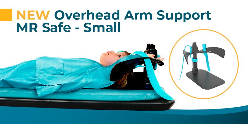 A child lies on a medical bed with a blue and black MR-safe overhead arm support device, also shown alone in an inset.