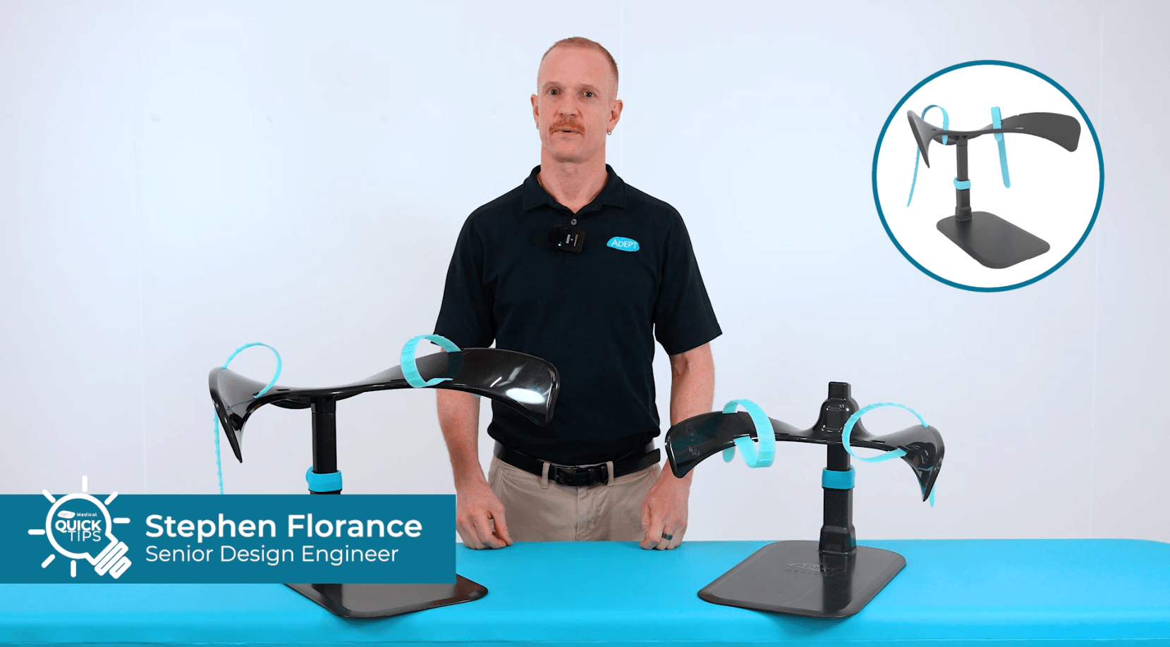 Stephen Florance, Senior Design Engineer, stands behind two black bicycle aerobars with blue accents on display stands. An inset shows one aerobar.